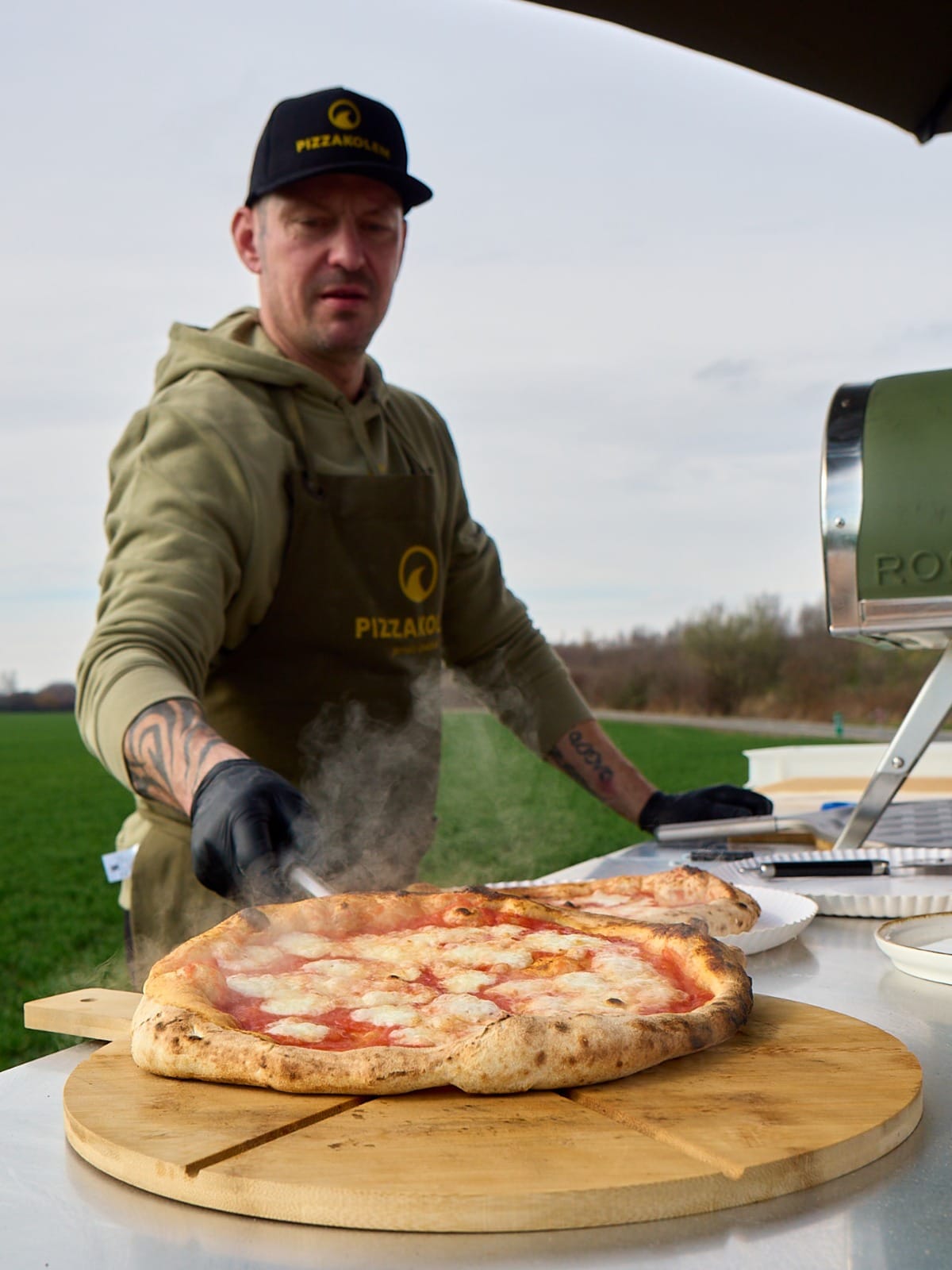 Šéf pizzař při přípravě pizzy venku